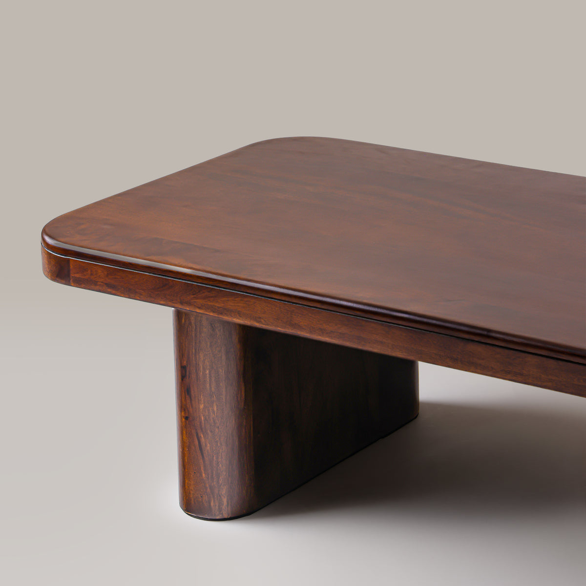 Close-up of the Cinder coffee table top corner and rounded slab leg