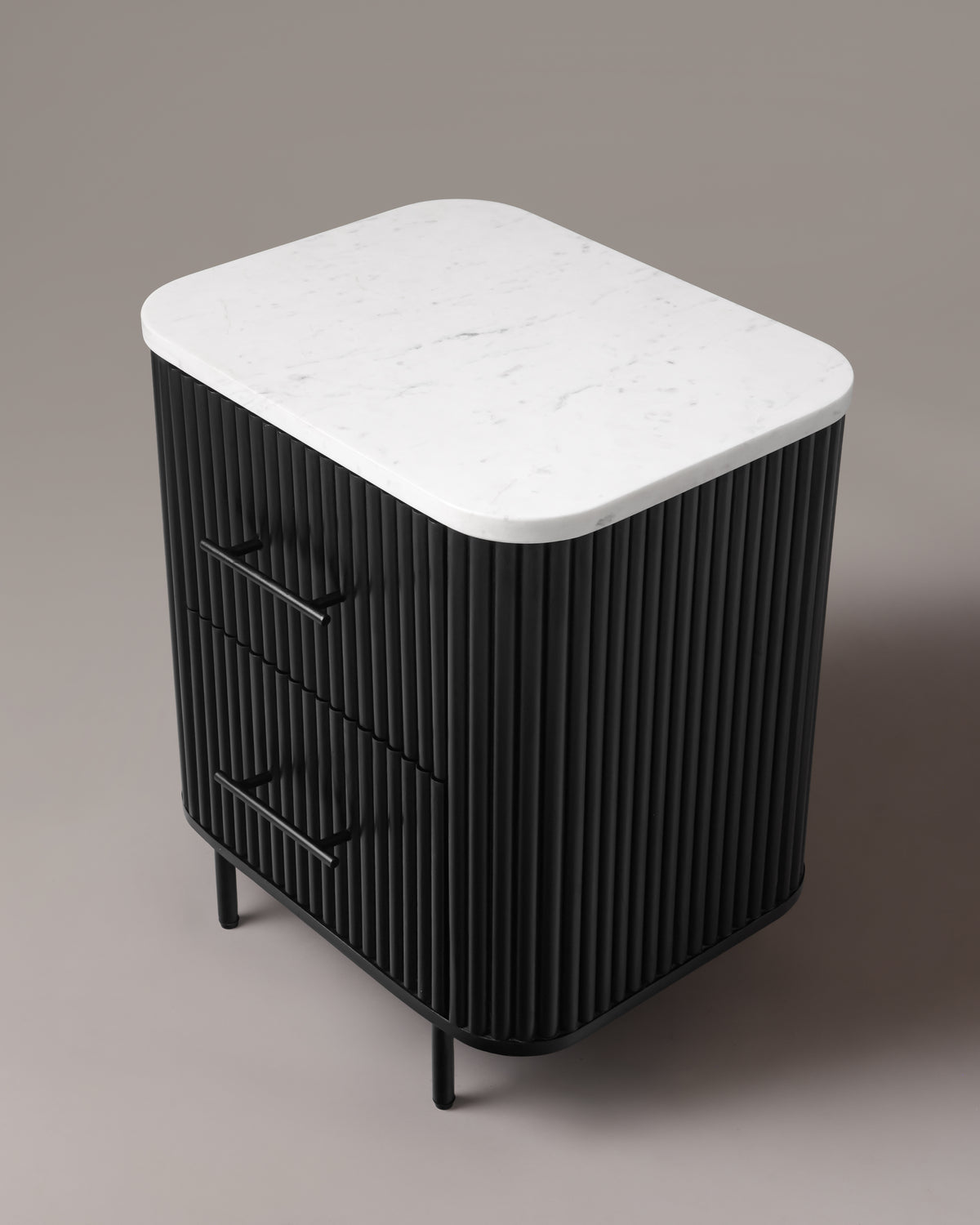 Kelby black bedside table from above showing the natural marble top