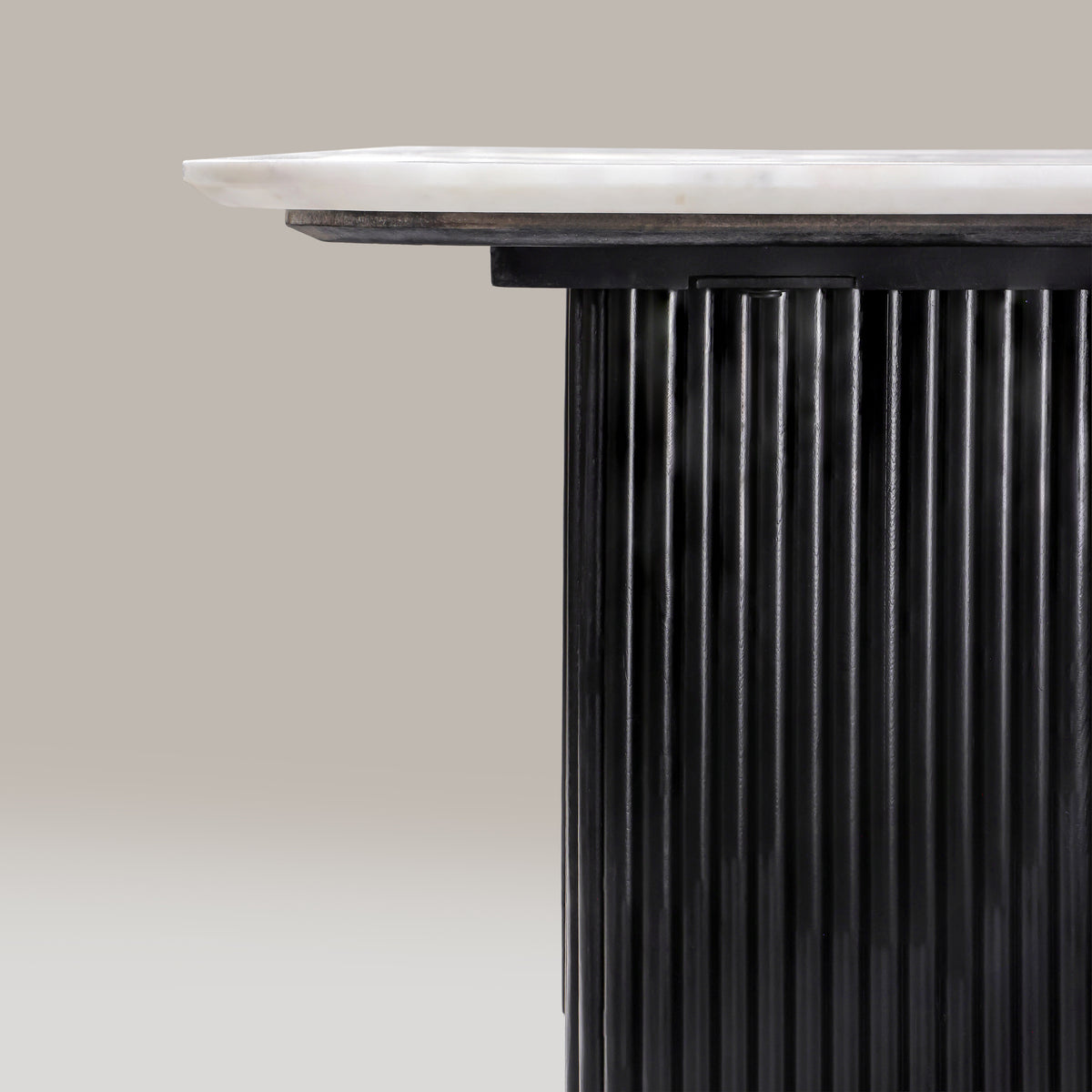 Detail of the Kelby dining table marble edge above the reeded leg