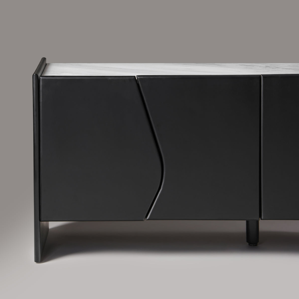 Close-up of wave-cut wood door join on Ares sideboard