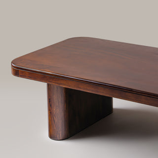 Close-up of the Cinder coffee table top corner and rounded slab leg