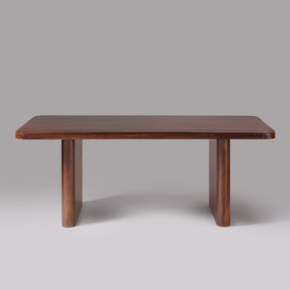 Cinder dining table angled view showing slab legs set in from the ends