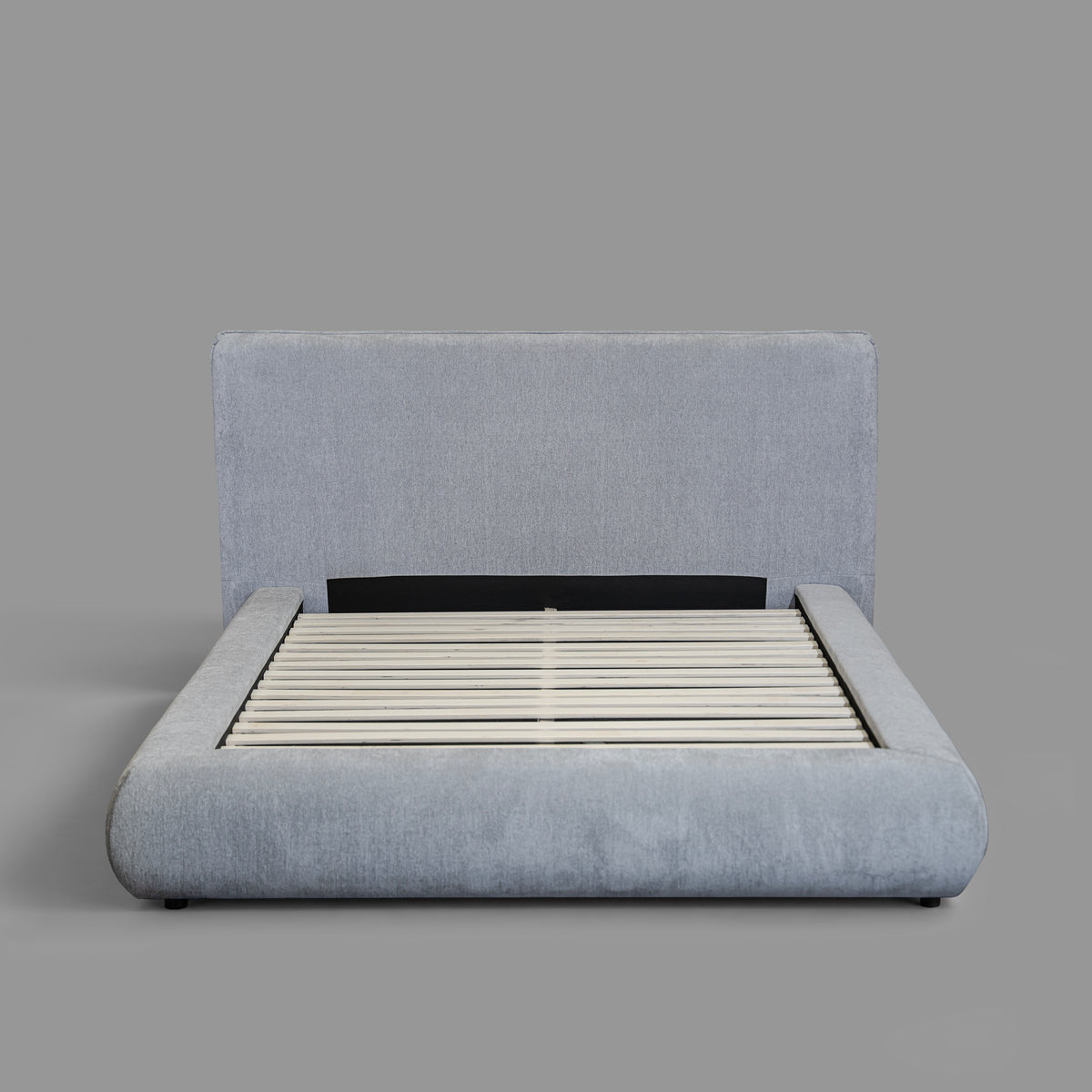 Haze Bed - front view, light grey upholstered bed frame with slatted base