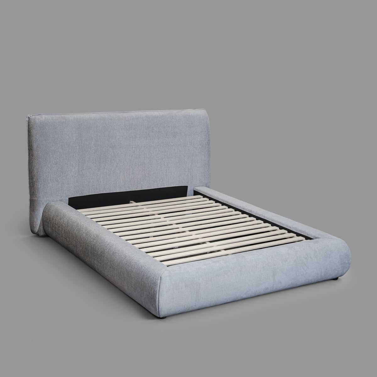 Haze Bed - angled view showing curved upholstered frame and headboard