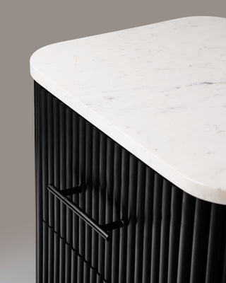 Close-up of the Kelby bedside table marble top and reeded front