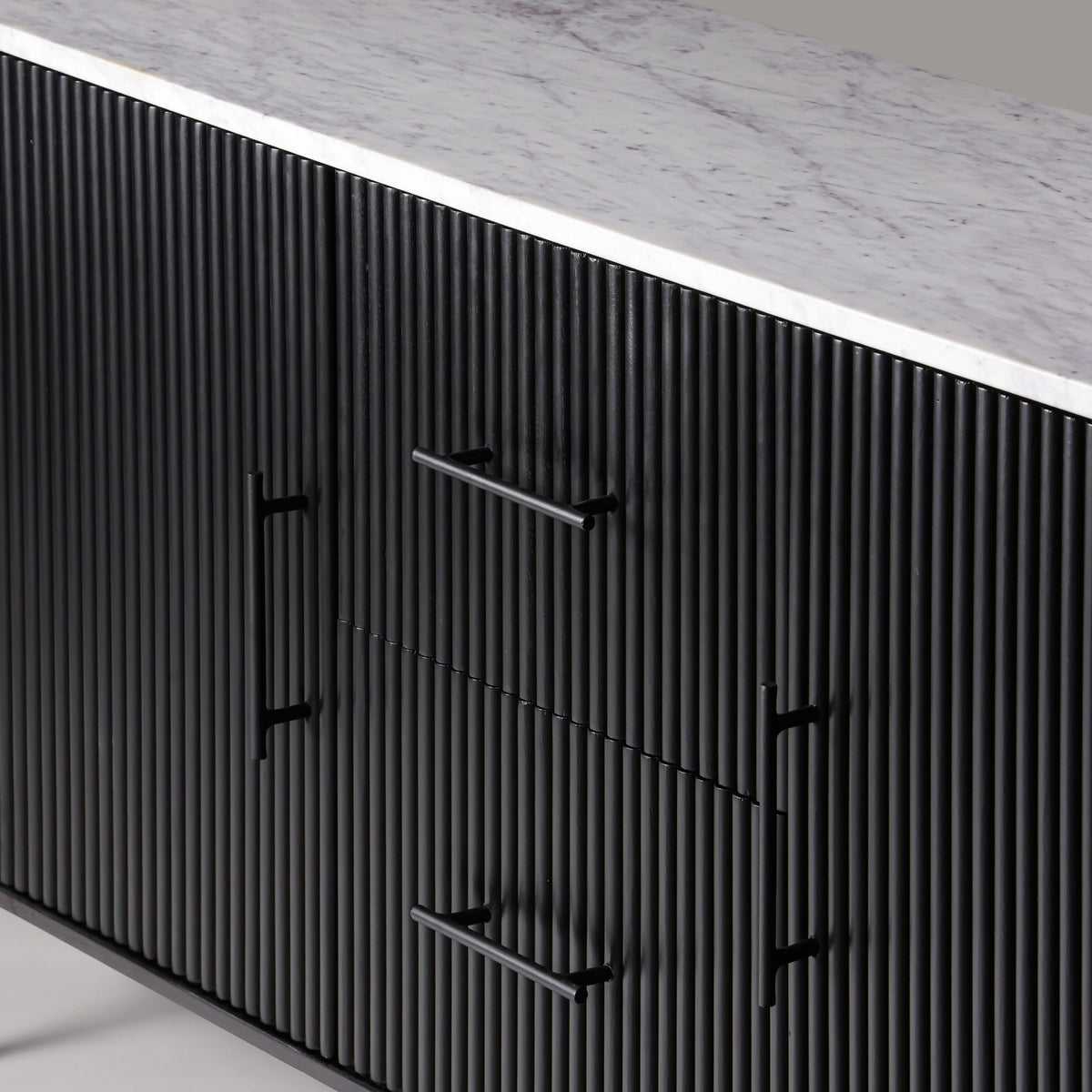 Close-up of the Kelby black buffet reeded front, handles and marble top