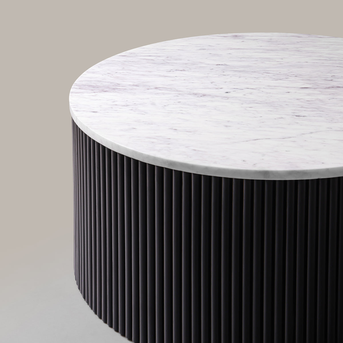 Close-up of the Kelby coffee table marble top and black reeded drum