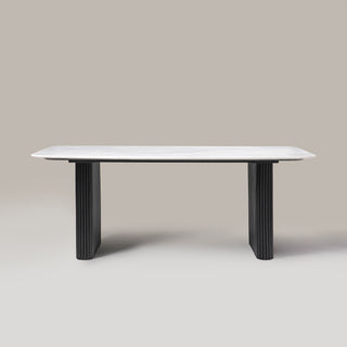Kelby natural marble dining table with black reeded wooden legs, front view