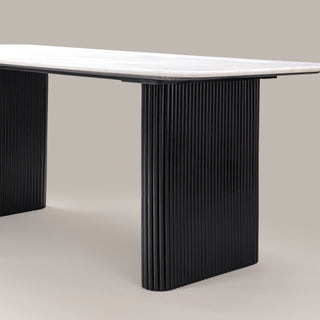 Close-up of the Kelby dining table black reeded leg and marble top