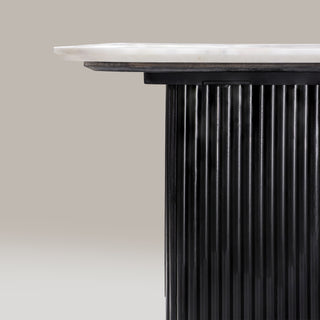 Detail of the Kelby dining table marble edge above the reeded leg