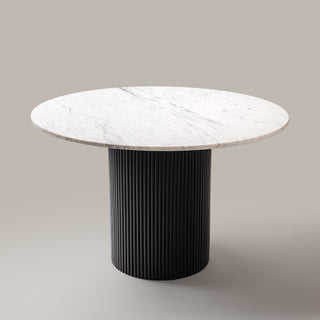 Kelby round marble dining table with black base, angled view