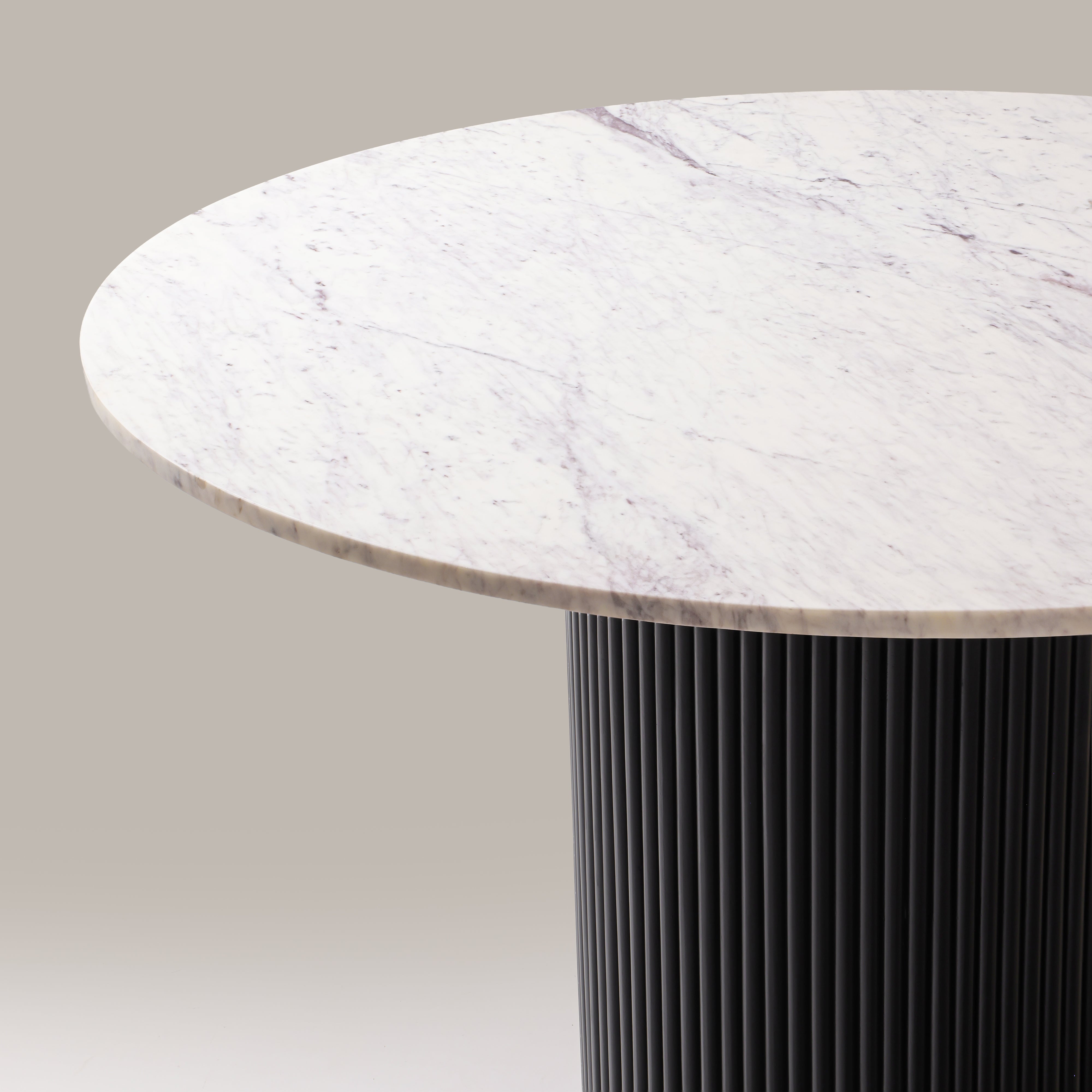 Close-up of the Kelby round dining table marble top and reeded pedestal
