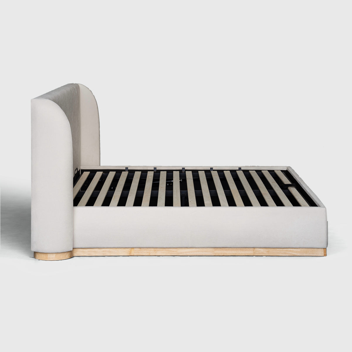 Bora Bed with Gaslift Storage side view showing curved headboard and timber plinth