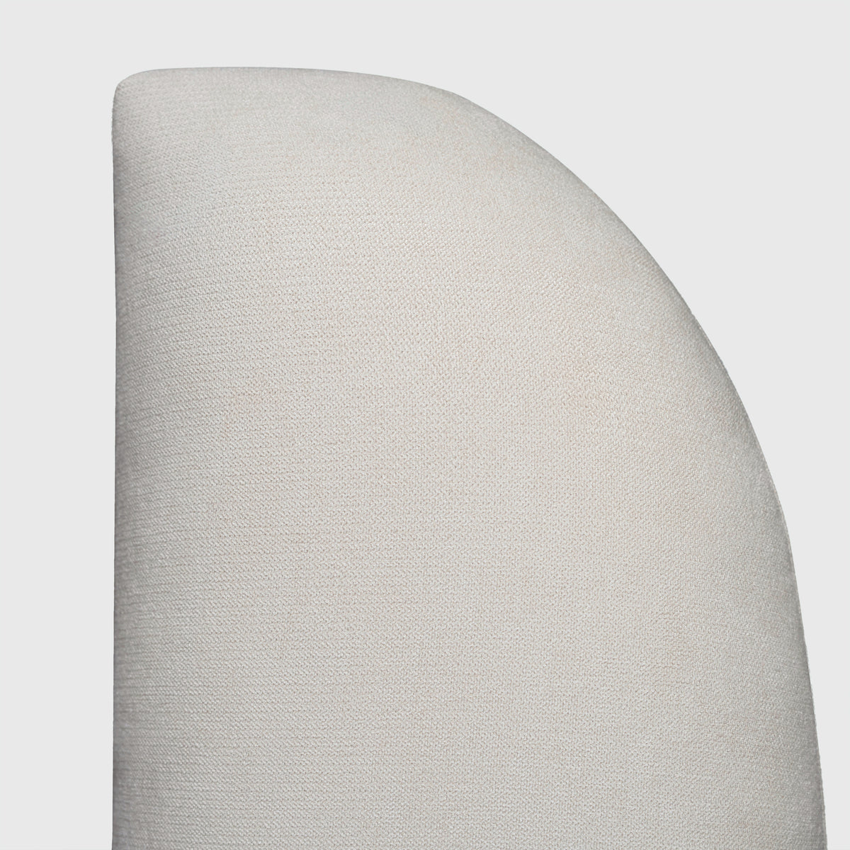 Bora Bed close-up of curved cream headboard edge