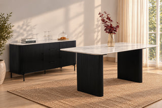Kelby black dining table, wide view in a styled dining room