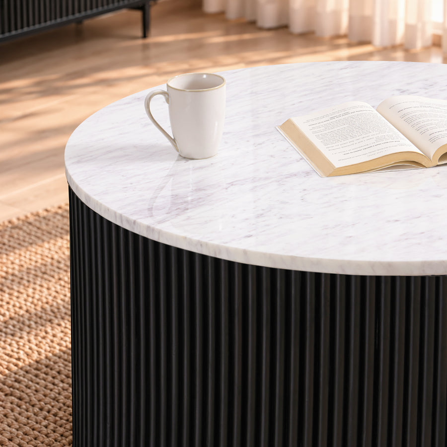 Close-up of the Kelby round coffee table marble top and black reeded drum