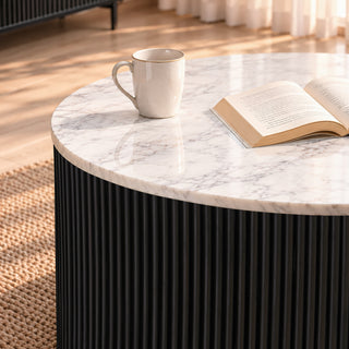 Close-up of the Kelby round coffee table marble top and black reeded drum